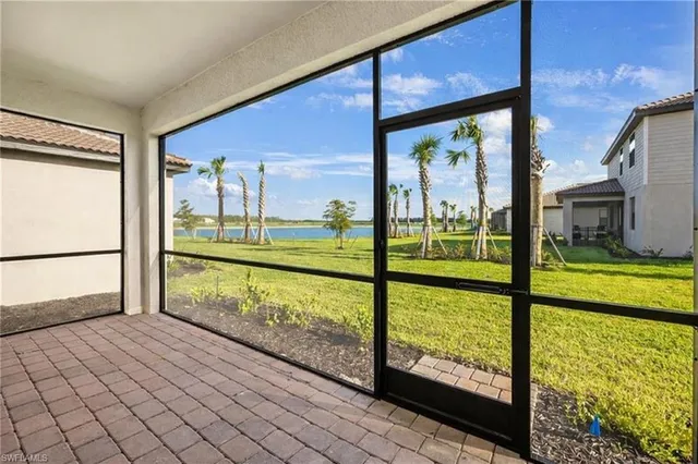 a view of an empty room with large windows