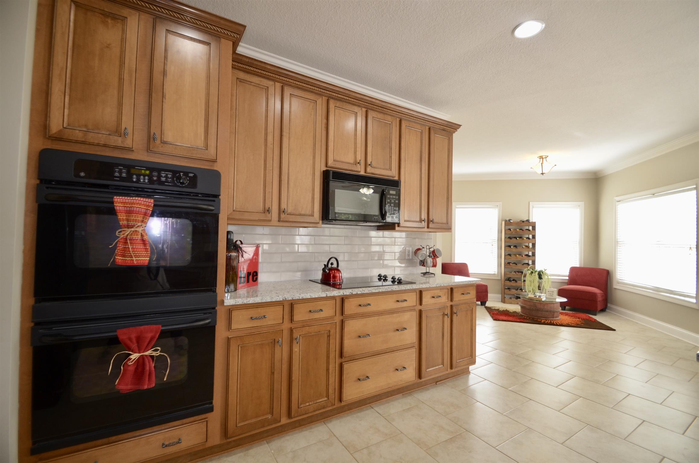 710 Dixie Bee Road Clarksville, TN 37043 - Photo 13 of 30 a kitchen with stainless steel appliances wooden cabinets and a stove top oven