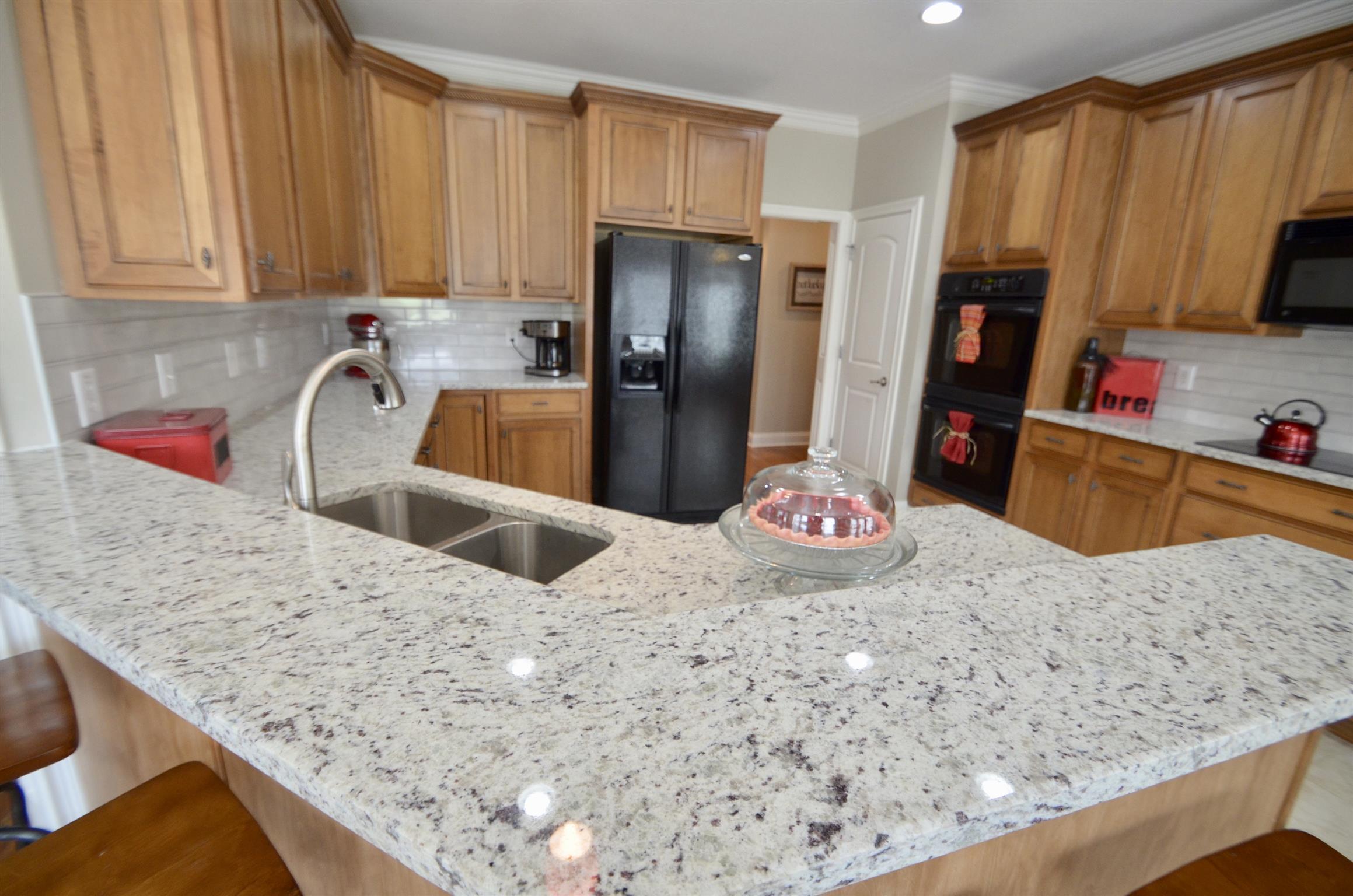 710 Dixie Bee Road Clarksville, TN 37043 - Photo 10 of 30 a kitchen with stainless steel appliances kitchen island granite countertop a refrigerator and stove