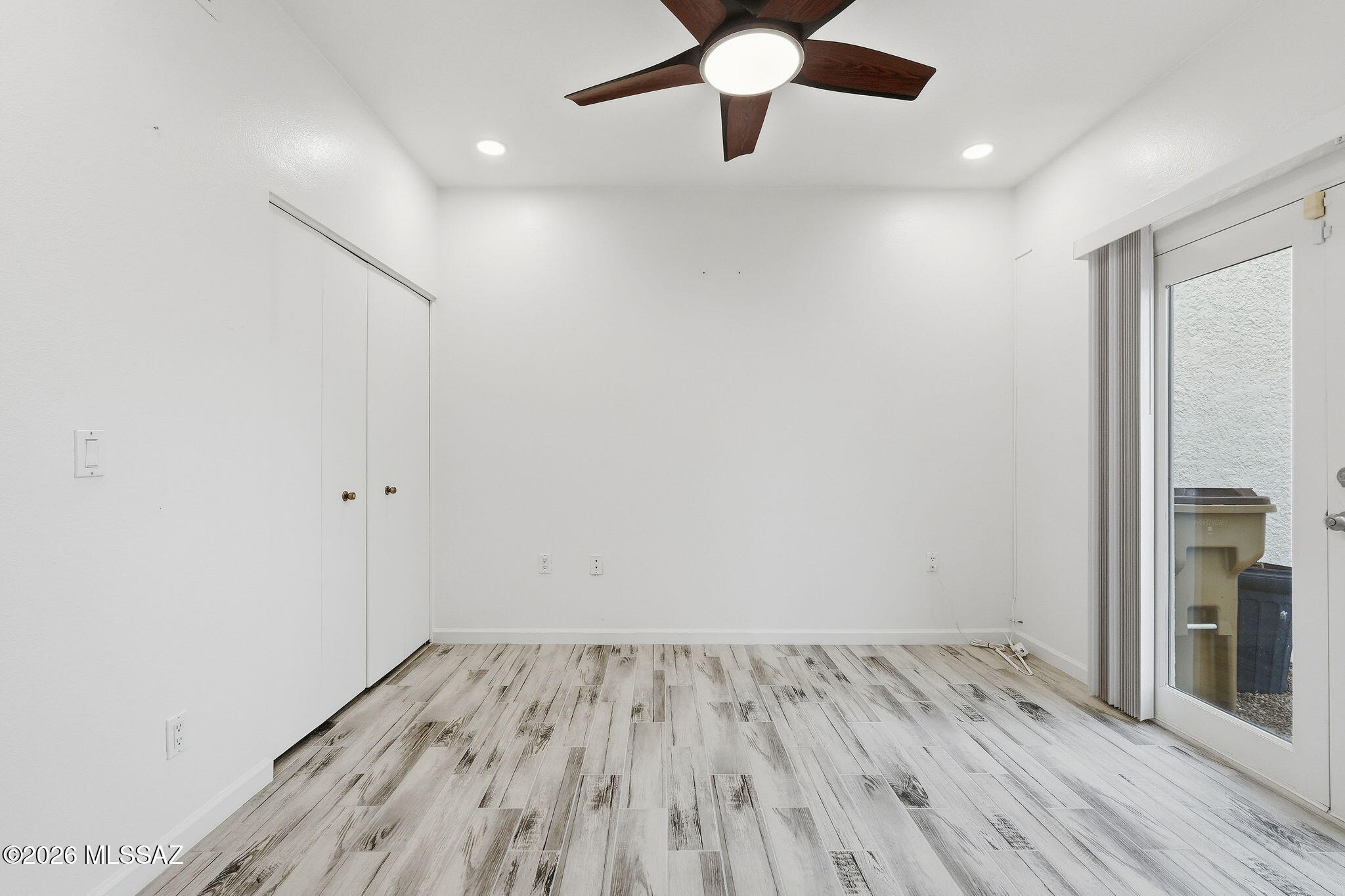1183 Circulo Canario Rio Rico, AZ 85648 - Photo 17 of 31 an empty room with wooden floor and a ceiling fan