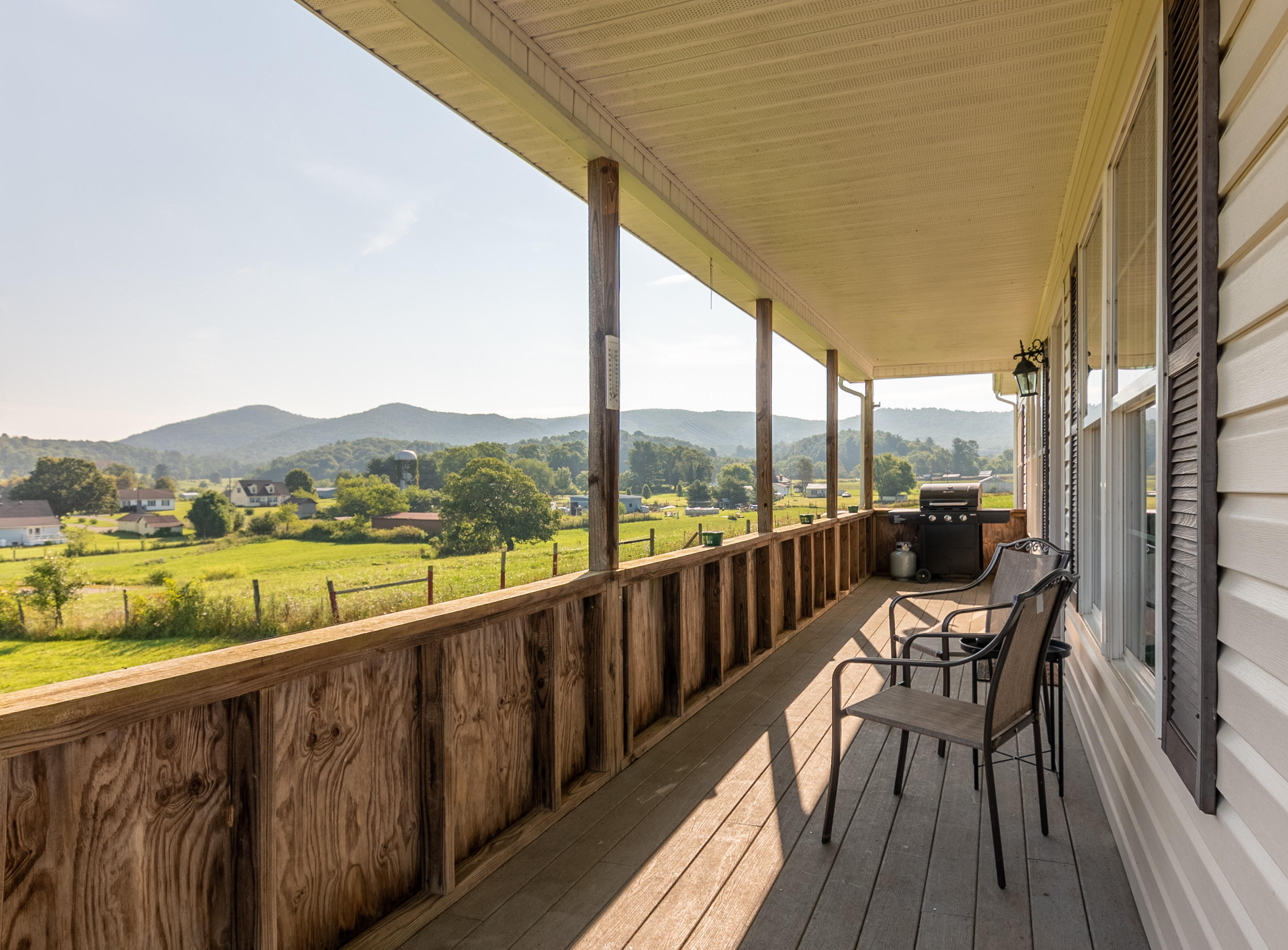 3850 Hopper Lane Riner, VA 24149 - Photo 16 of 50 a view of a balcony with lake view and wooden floor