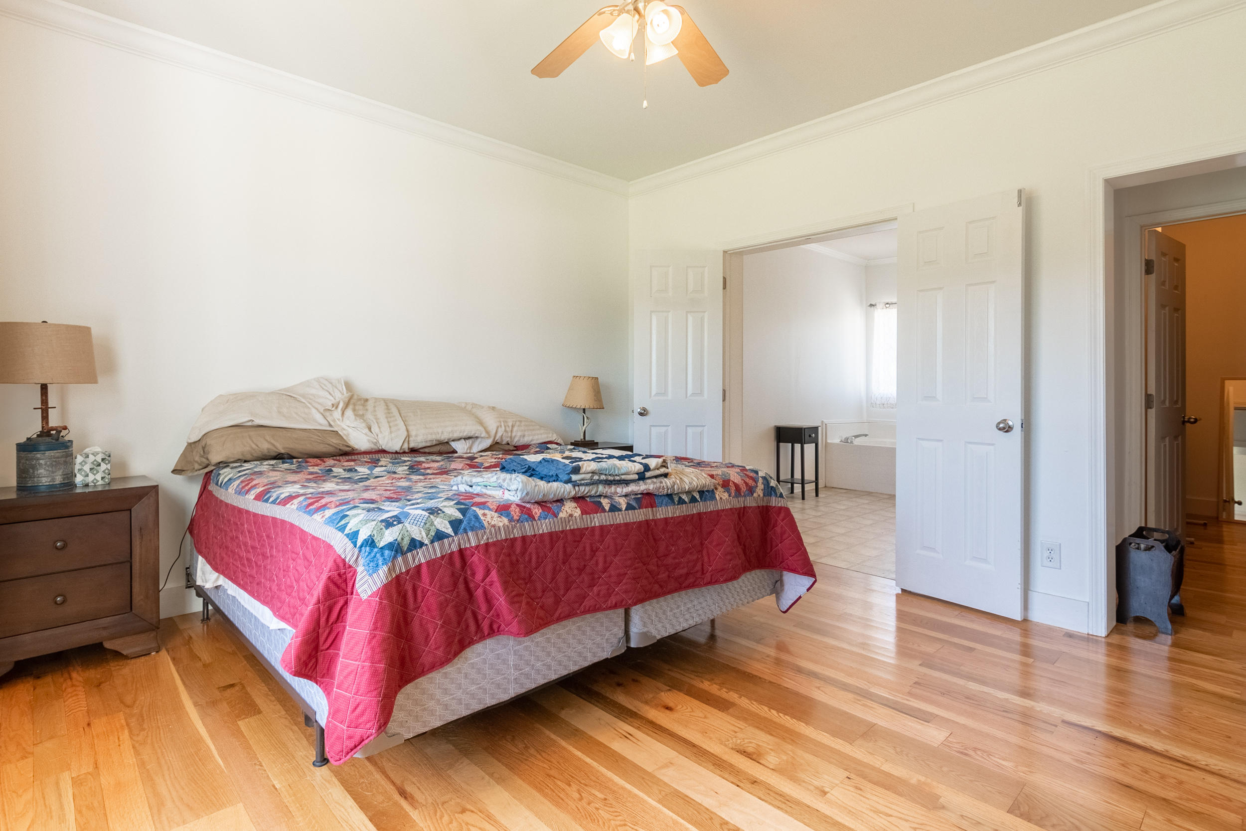 3850 Hopper Lane Riner, VA 24149 - Photo 28 of 50 a bedroom with a bed and a chandelier