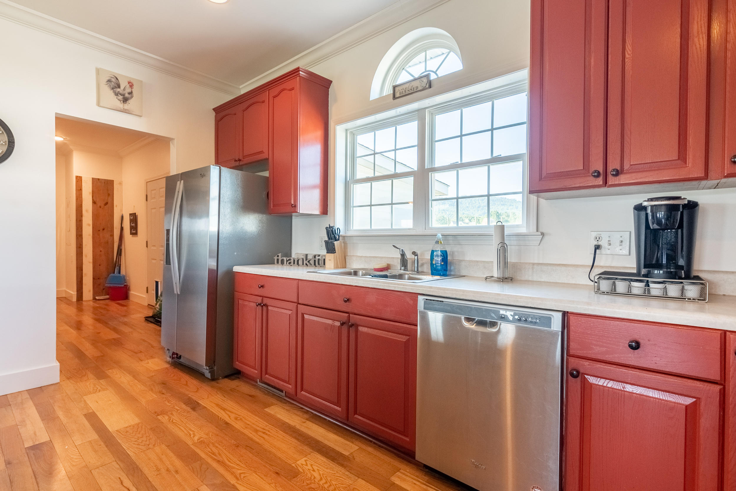 3850 Hopper Lane Riner, VA 24149 - Photo 34 of 50 a kitchen with stainless steel appliances granite countertop a refrigerator a sink dishwasher and wooden cabinets with wooden floor