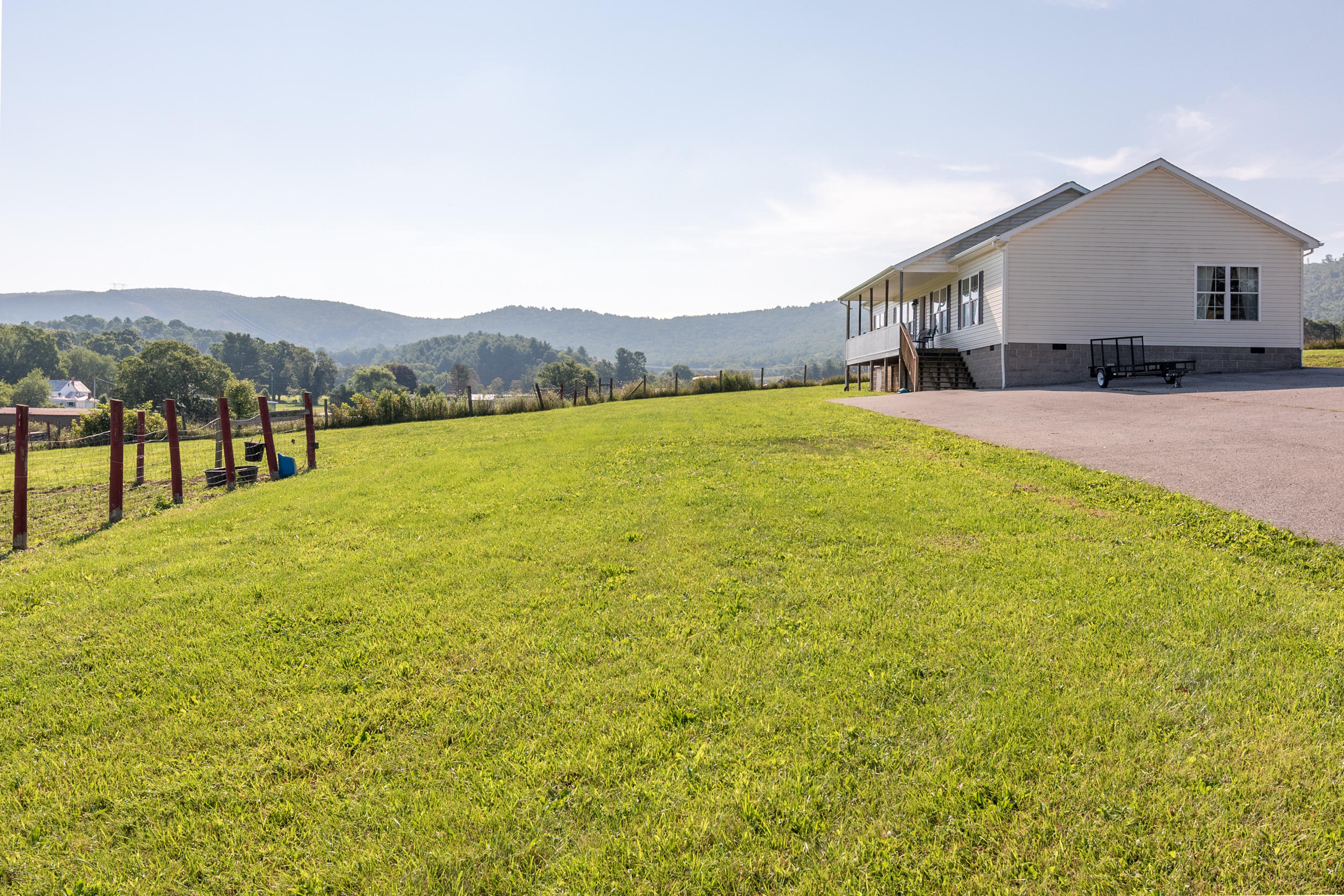 3850 Hopper Lane Riner, VA 24149 - Photo 49 of 50 a view of a house with a yard and sitting area