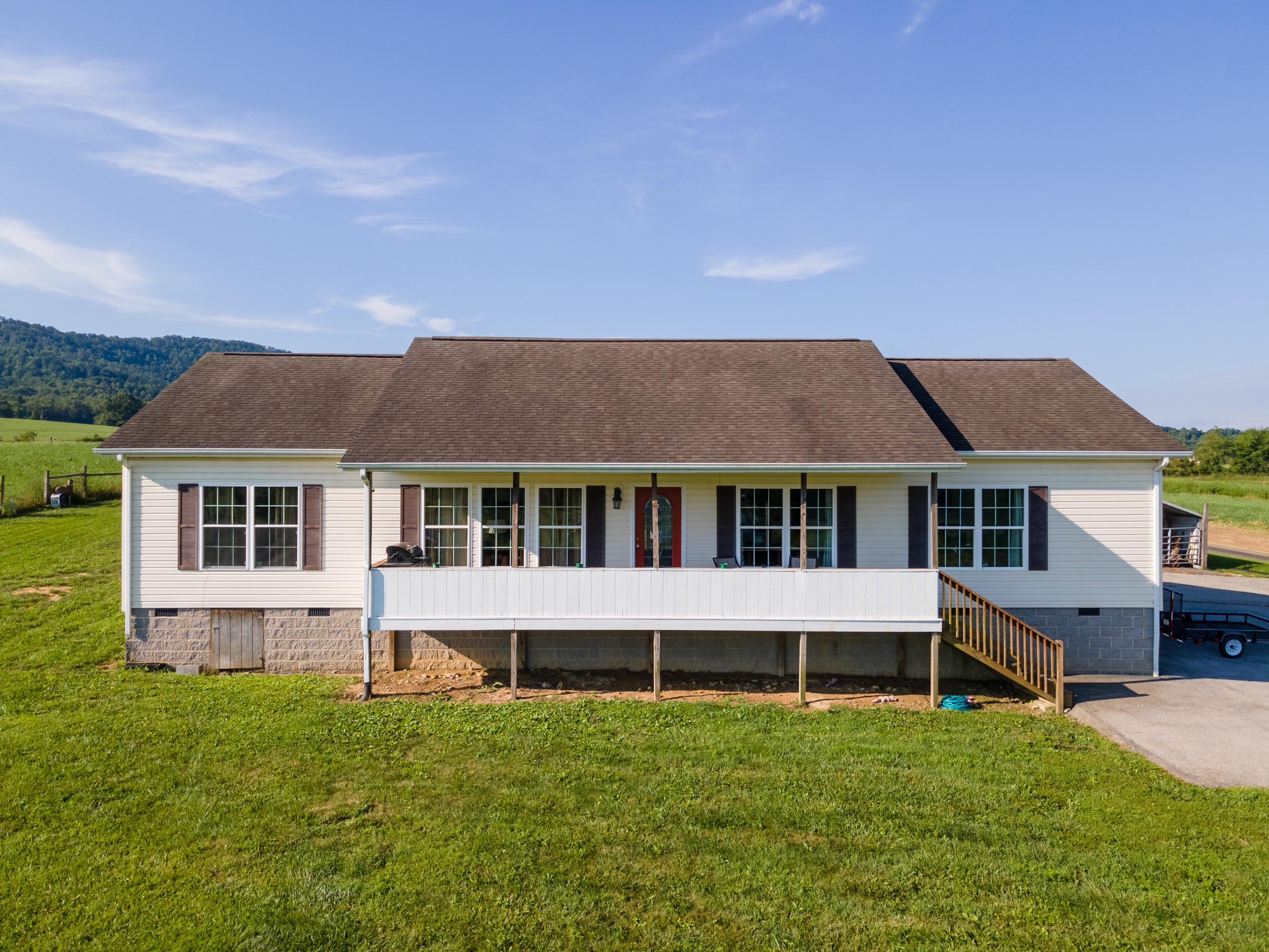 3850 Hopper Lane Riner, VA 24149 - Photo 8 of 50 a house that is sitting in the grass with large windows