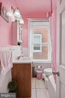 a bathroom with a sink mirror and a bathtub