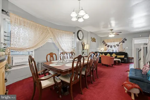 a outdoor dining area with furniture and a chandelier