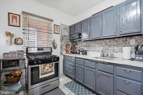 a kitchen with stainless steel appliances granite countertop a stove and cabinets