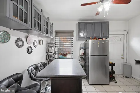 a kitchen with a refrigerator a stove a sink and a cabinets
