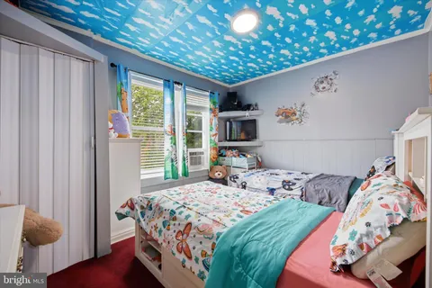 a bedroom with a bed and a window with the outer view