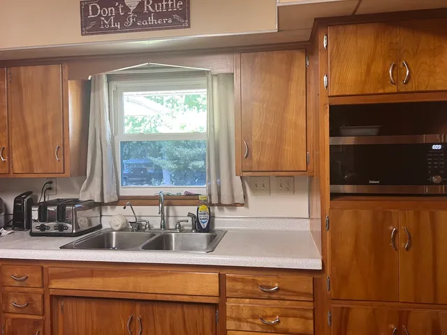 a kitchen with stainless steel appliances granite countertop a sink and a cabinets
