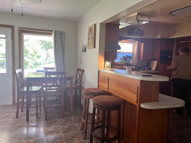 a view of a dining room with furniture and window