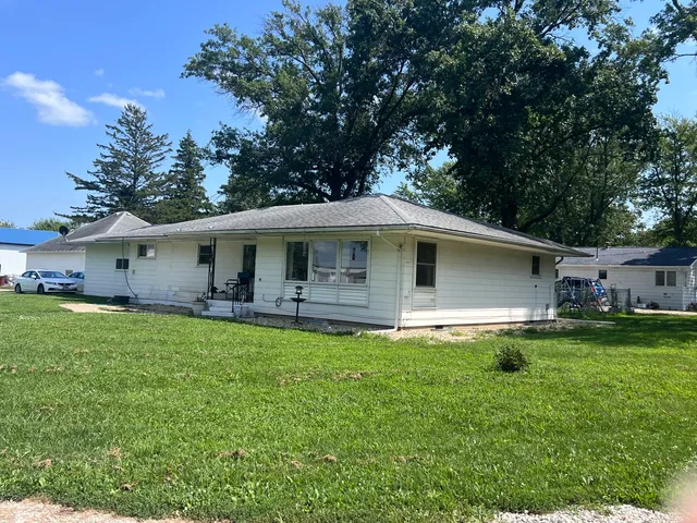 a front view of house with a garden