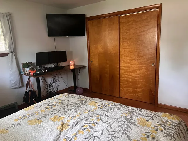 a bedroom with a bed and a flat screen tv