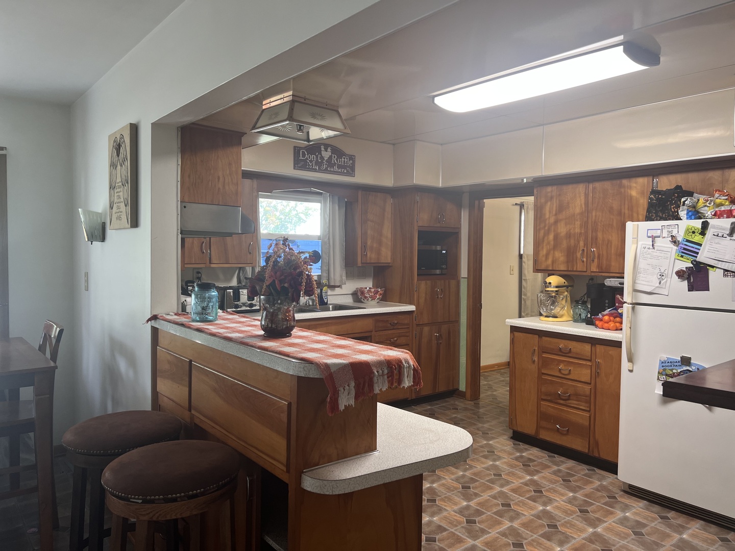 301 Dilks Street Roberts, IL 60962 - Photo 6 of 44 a dining hall with granite countertop a stove a sink dishwasher a dining table and chairs with wooden floor