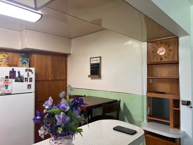 a kitchen with a refrigerator and cabinets