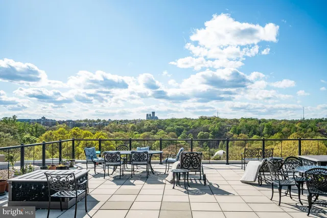 a view of a lake with couches chairs