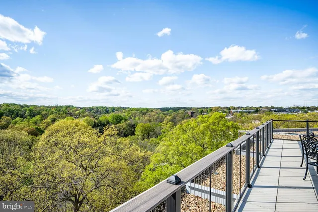a view of a balcony next to a yard