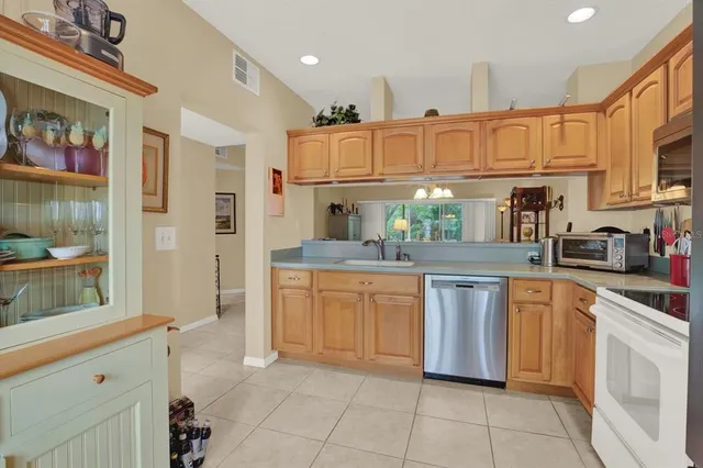 a kitchen with stainless steel appliances granite countertop a sink and cabinets