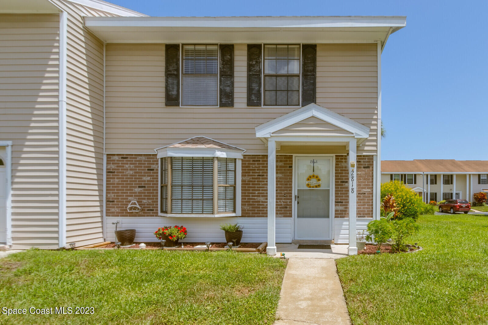 2818 Manor Drive Northeast Palm Bay, FL 32905 - Photo 1 of 1 a front view of a house with a yard