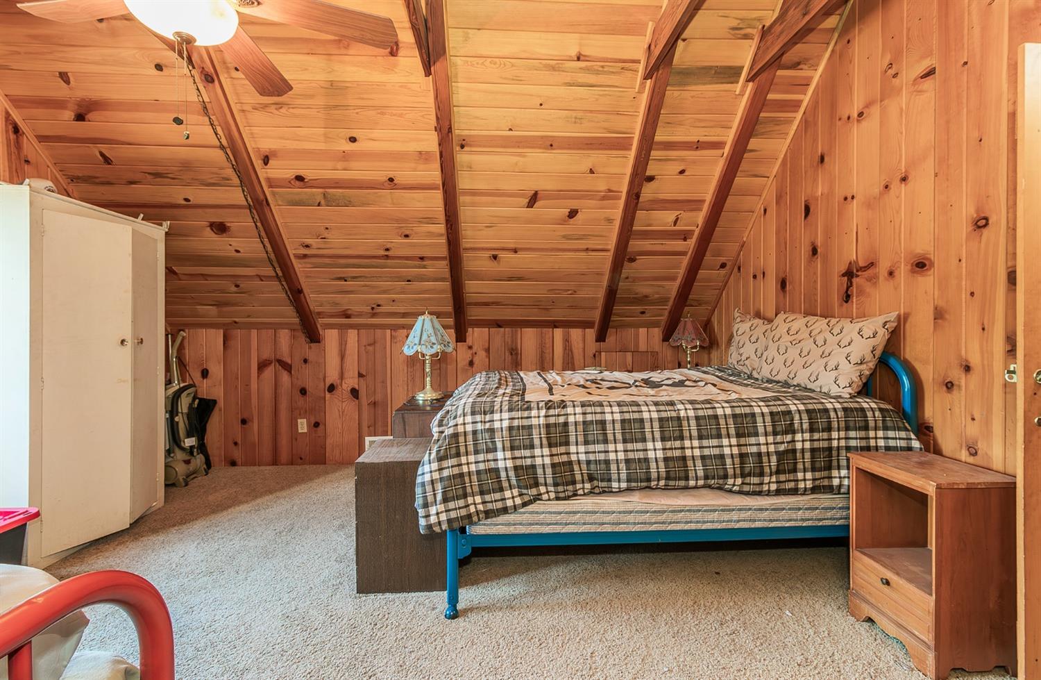 33288 Linson Road Tollhouse, CA 93667 - Photo 13 of 54 a blue bed sitting in a room next to a window