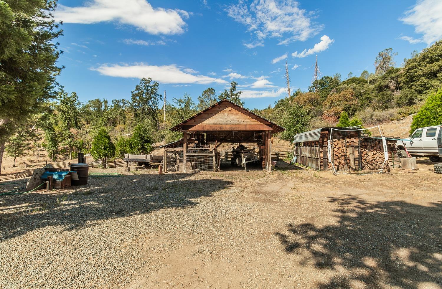 33288 Linson Road Tollhouse, CA 93667 - Photo 20 of 54 a front view of a house with a yard and garage