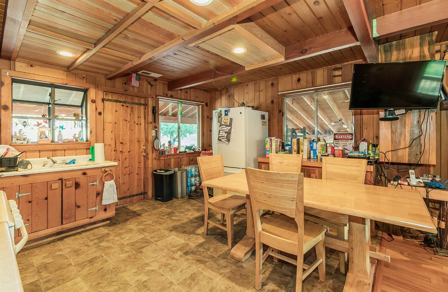 33288 Linson Road Tollhouse, CA 93667 - Photo 6 of 54 a dining room with furniture and a flat screen tv