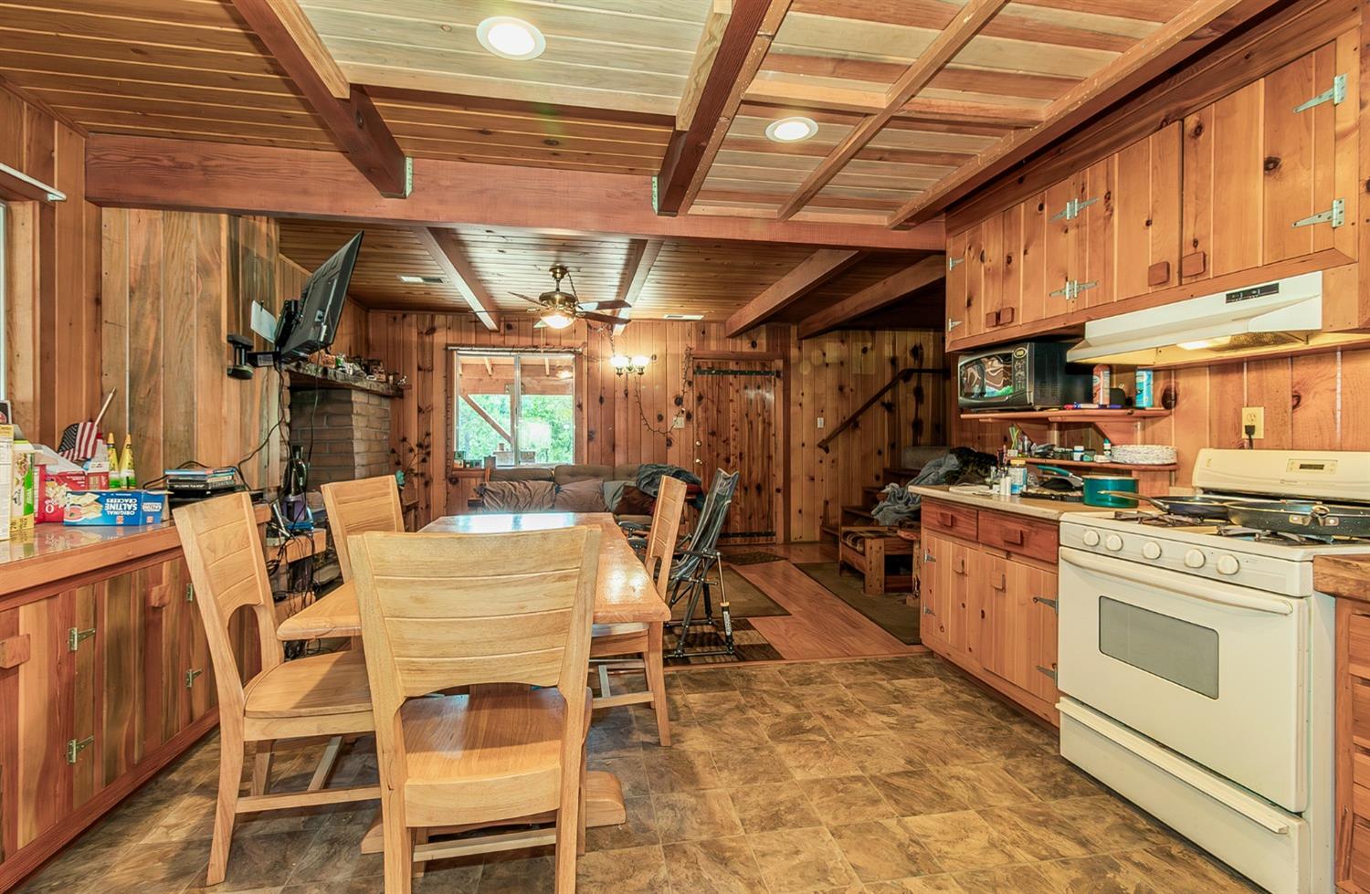 33288 Linson Road Tollhouse, CA 93667 - Photo 7 of 54 a kitchen with a dining table chairs and white appliances