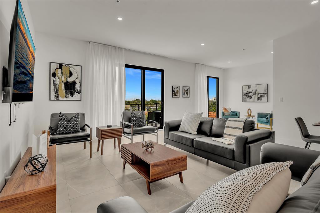 a living room with furniture potted plant and a window