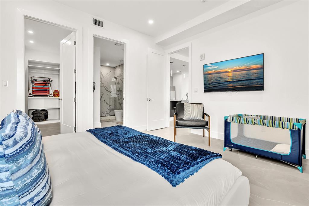 2100 Miami Road, Unit 403 Fort Lauderdale, FL 33316 - Photo 14 of 38 a bedroom with a bed and a flat screen tv