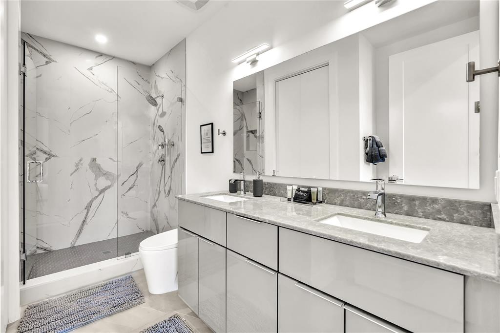 2100 Miami Road, Unit 403 Fort Lauderdale, FL 33316 - Photo 15 of 38 a bathroom with a granite countertop sink toilet and shower