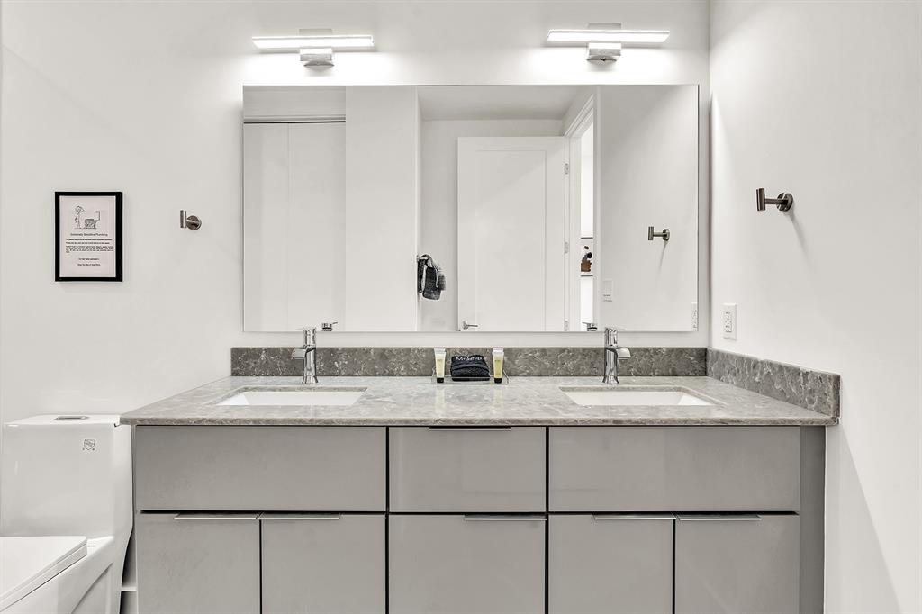 2100 Miami Road, Unit 403 Fort Lauderdale, FL 33316 - Photo 16 of 38 a bathroom with a granite countertop sink and a mirror