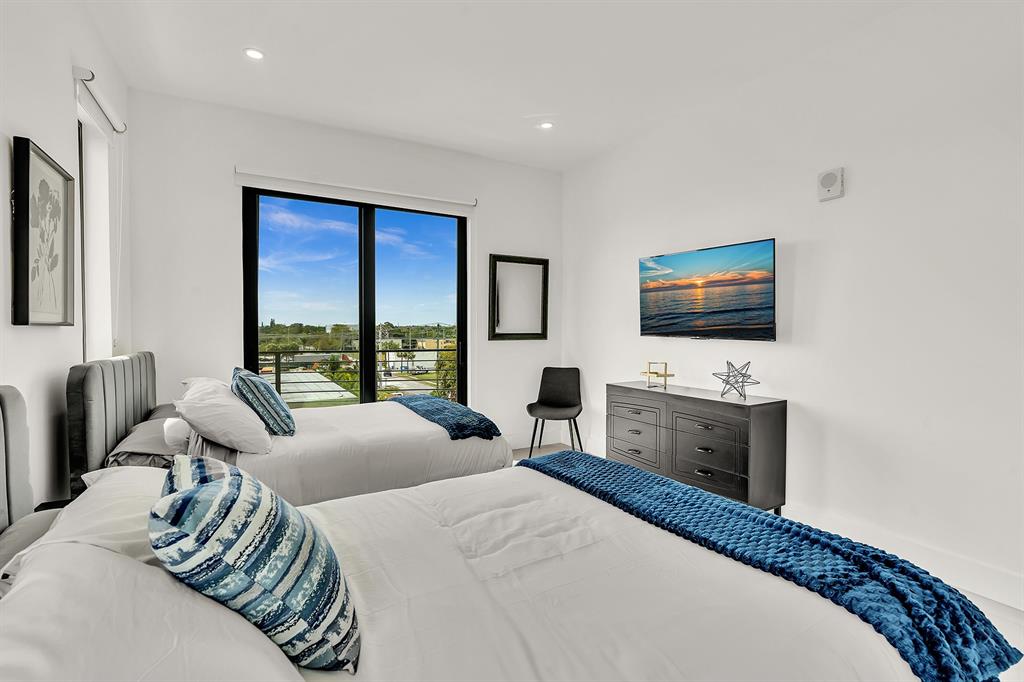 2100 Miami Road, Unit 403 Fort Lauderdale, FL 33316 - Photo 20 of 38 a bedroom with a bed and a flat screen tv