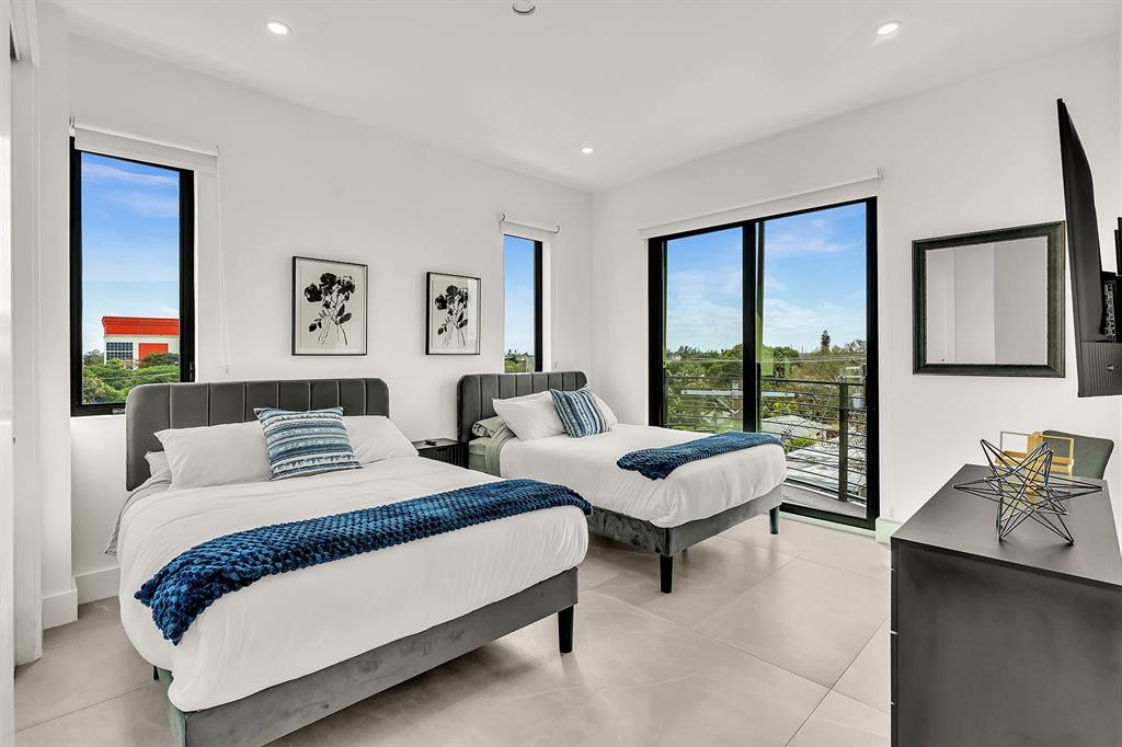 2100 Miami Road, Unit 403 Fort Lauderdale, FL 33316 - Photo 21 of 38 a spacious bedroom with a bed and a large window