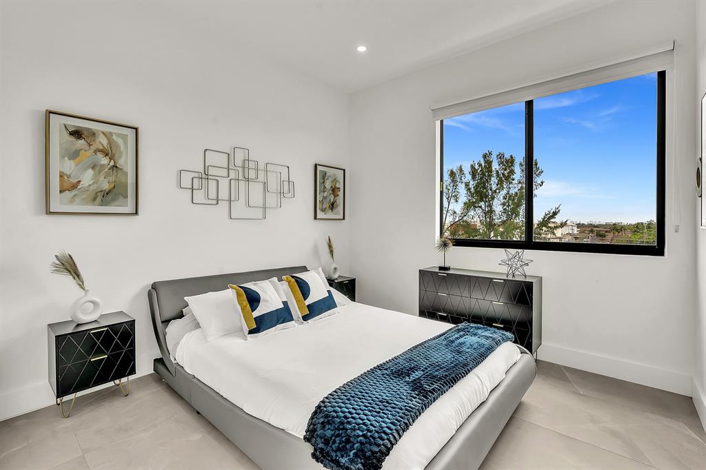 2100 Miami Road, Unit 403 Fort Lauderdale, FL 33316 - Photo 23 of 38 a bedroom with a bed and a painting on the wall