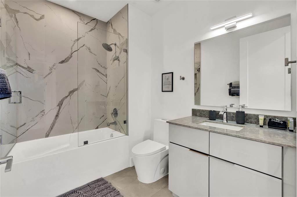 2100 Miami Road, Unit 403 Fort Lauderdale, FL 33316 - Photo 25 of 38 a bathroom with a granite countertop sink a toilet and shower