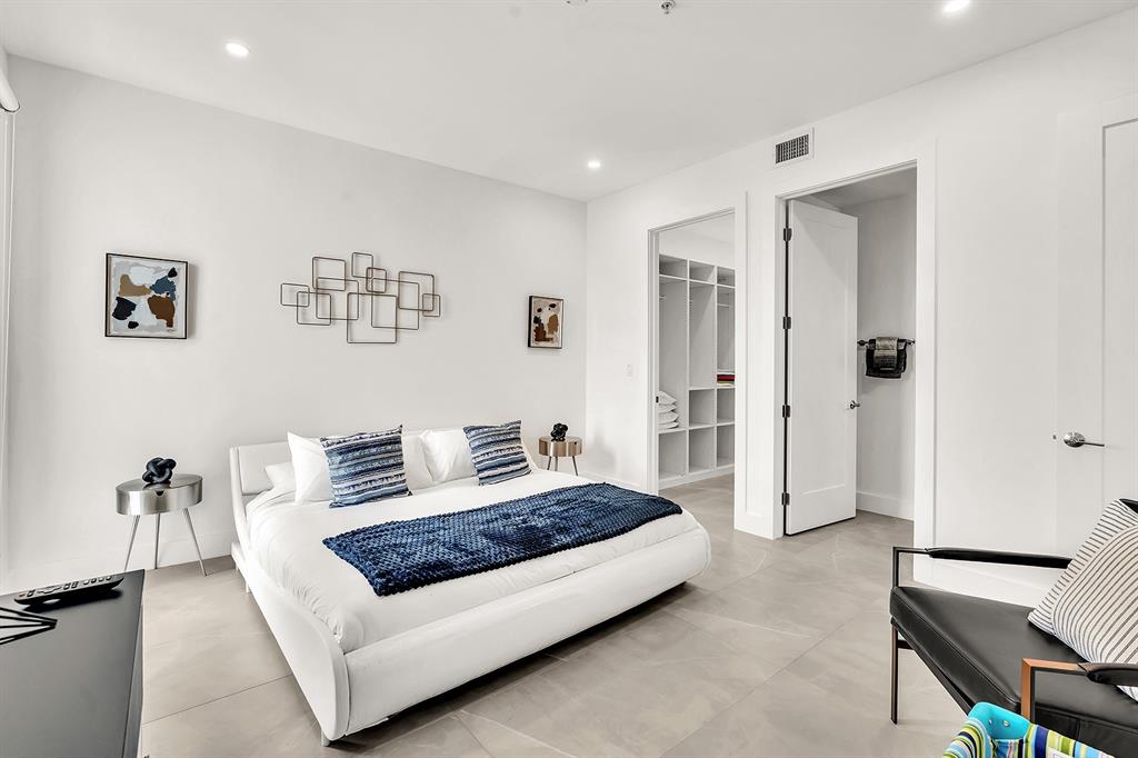 2100 Miami Road, Unit 403 Fort Lauderdale, FL 33316 - Photo 28 of 38 a spacious bedroom with a bed and a couch