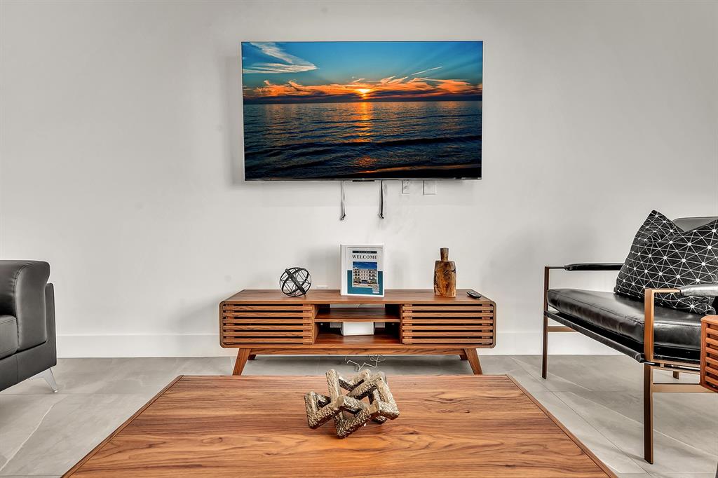 2100 Miami Road, Unit 403 Fort Lauderdale, FL 33316 - Photo 29 of 38 a living room with furniture and a flat screen tv