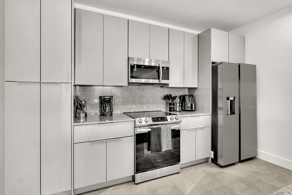 2100 Miami Road, Unit 403 Fort Lauderdale, FL 33316 - Photo 30 of 38 a kitchen with cabinets stainless steel appliances and a counter space