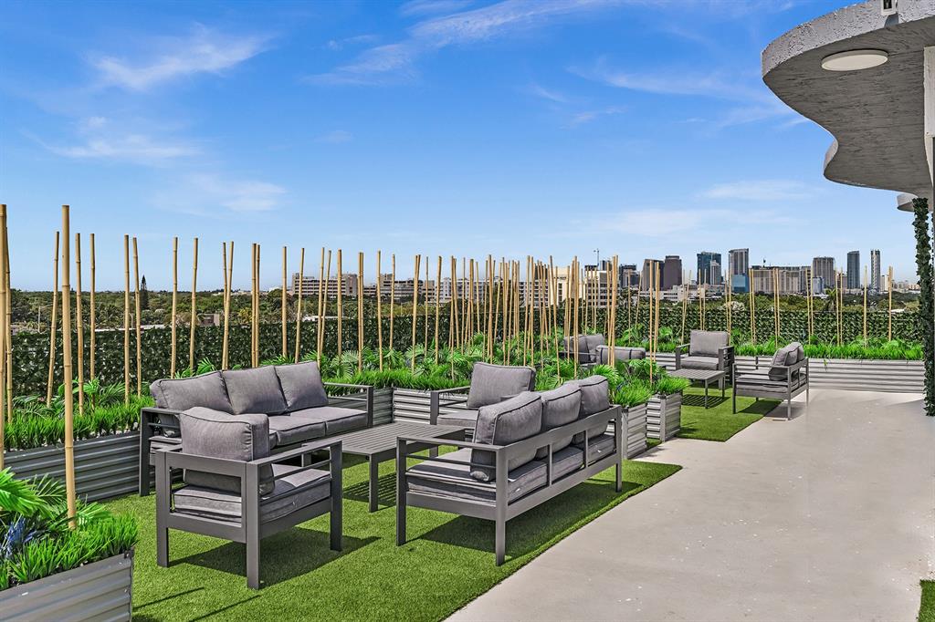 2100 Miami Road, Unit 403 Fort Lauderdale, FL 33316 - Photo 36 of 38 a view of a patio with couches chairs and a fire pit