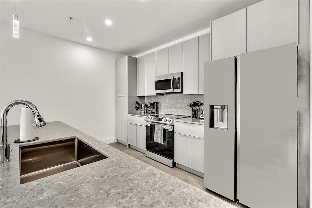 2100 Miami Road, Unit 403 Fort Lauderdale, FL 33316 - Photo 6 of 38 a kitchen with stainless steel appliances a refrigerator stove and microwave