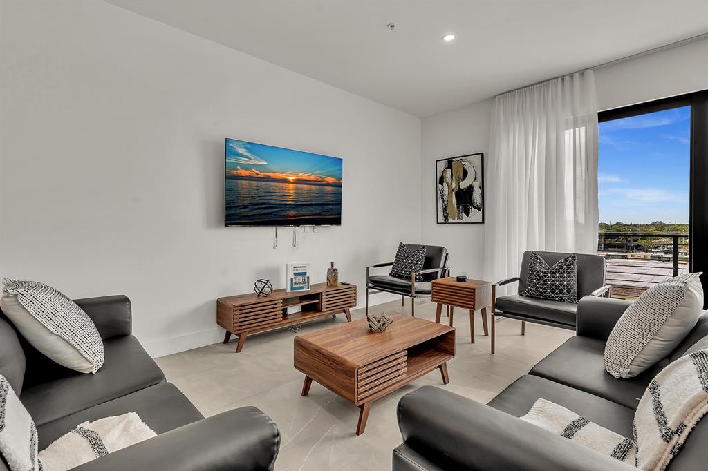 2100 Miami Road, Unit 403 Fort Lauderdale, FL 33316 - Photo 9 of 38 a living room with furniture and a flat screen tv