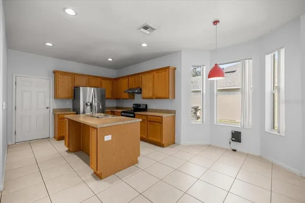 a kitchen with stainless steel appliances granite countertop a stove and a refrigerator