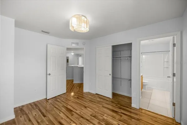 a bedroom with a bed and a mirror