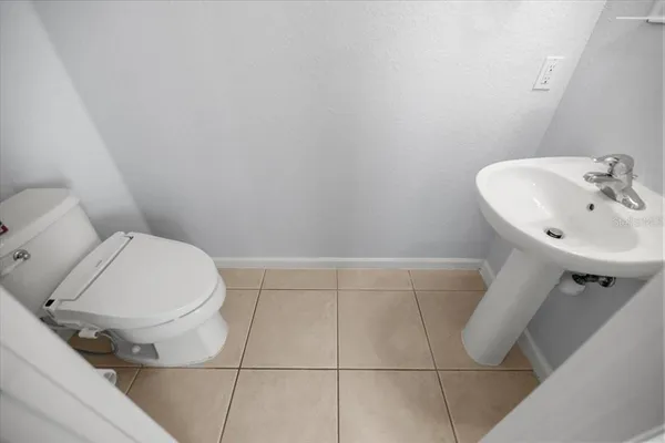 a white toilet sitting next to a bathroom sink