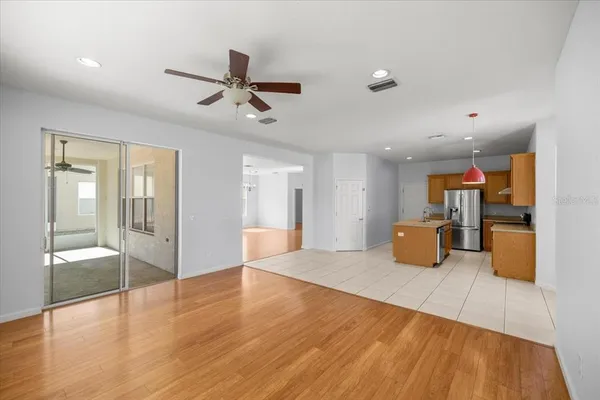 a view of a livingroom with wooden floor and furniture