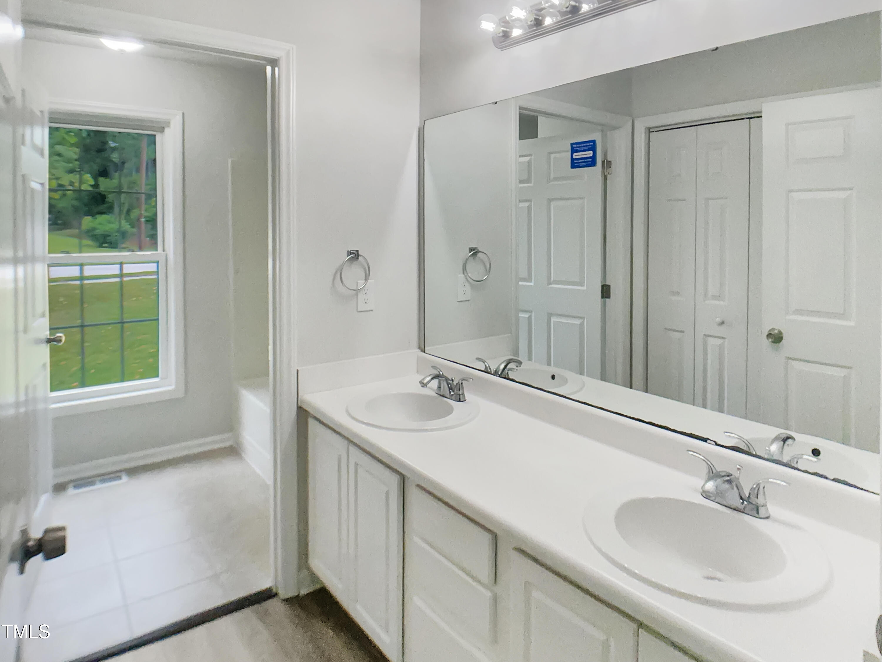 3509 Neptune Drive Raleigh, NC 27604 - Photo 7 of 18 a bathroom with a sink and a mirror