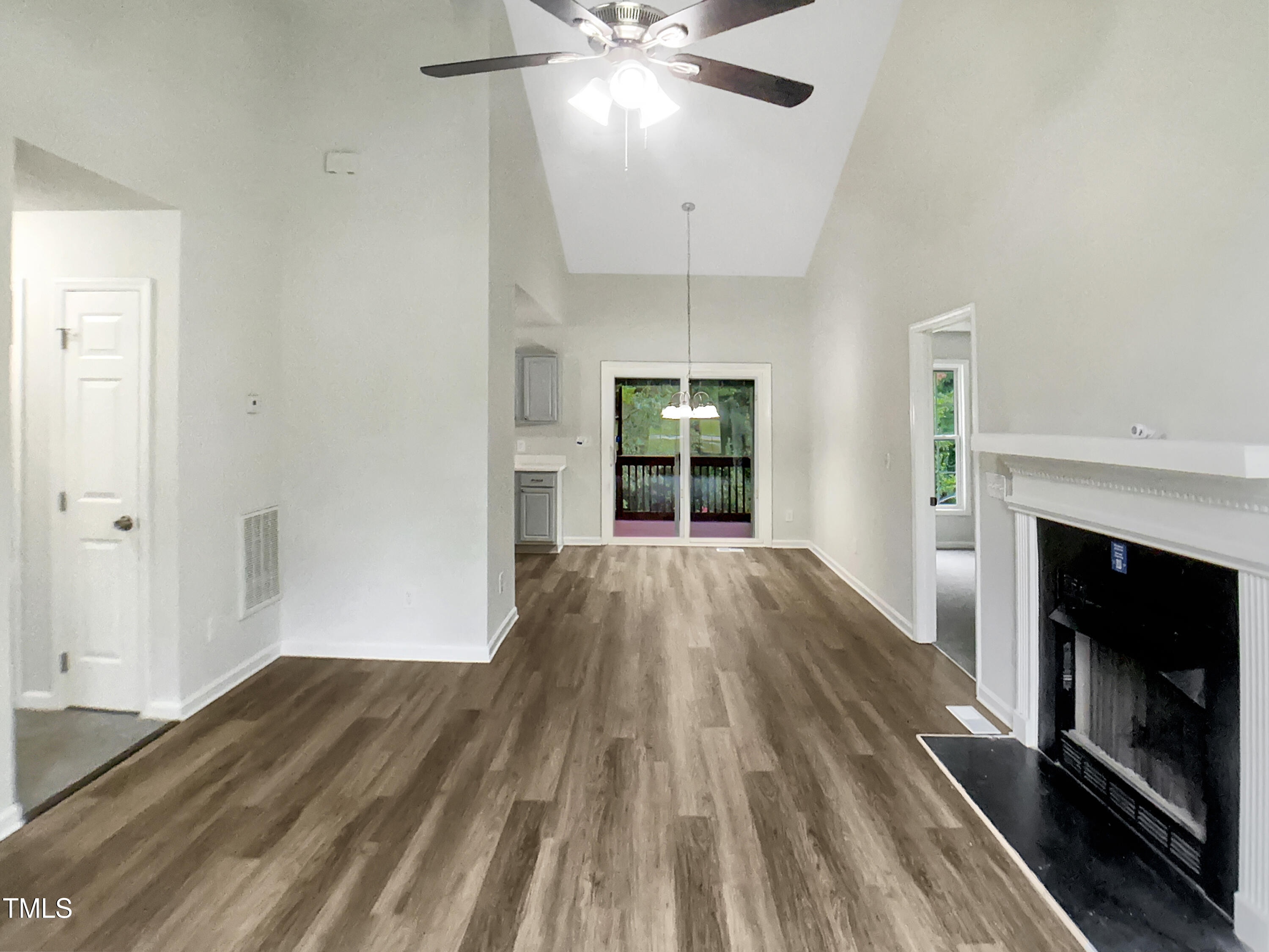 3509 Neptune Drive Raleigh, NC 27604 - Photo 10 of 18 wooden floor in an empty room with a fireplace