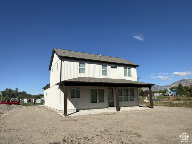 658 West 500 South, Unit 2 Logan, UT 84321 - Photo 17 of 18 Two-story residence with vertical siding, covered patio, and a shingled roof