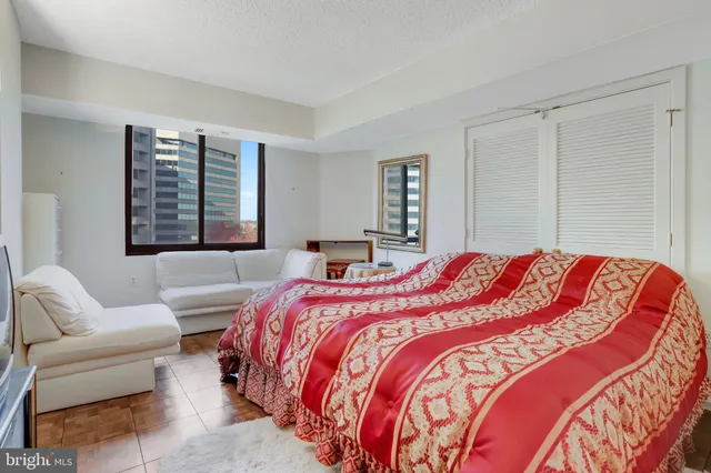 a bedroom with a bed and a couch